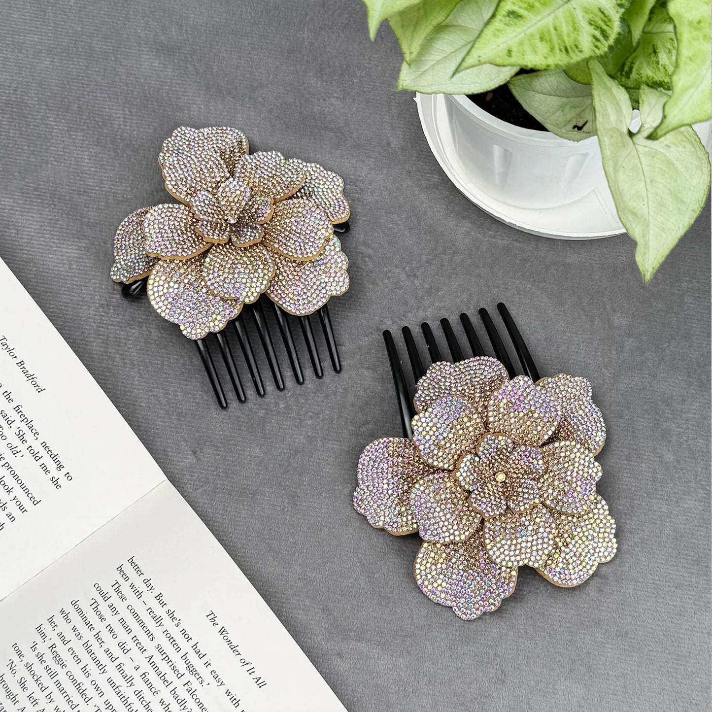 Two decorative side hair combs with floral designs on a gray surface.