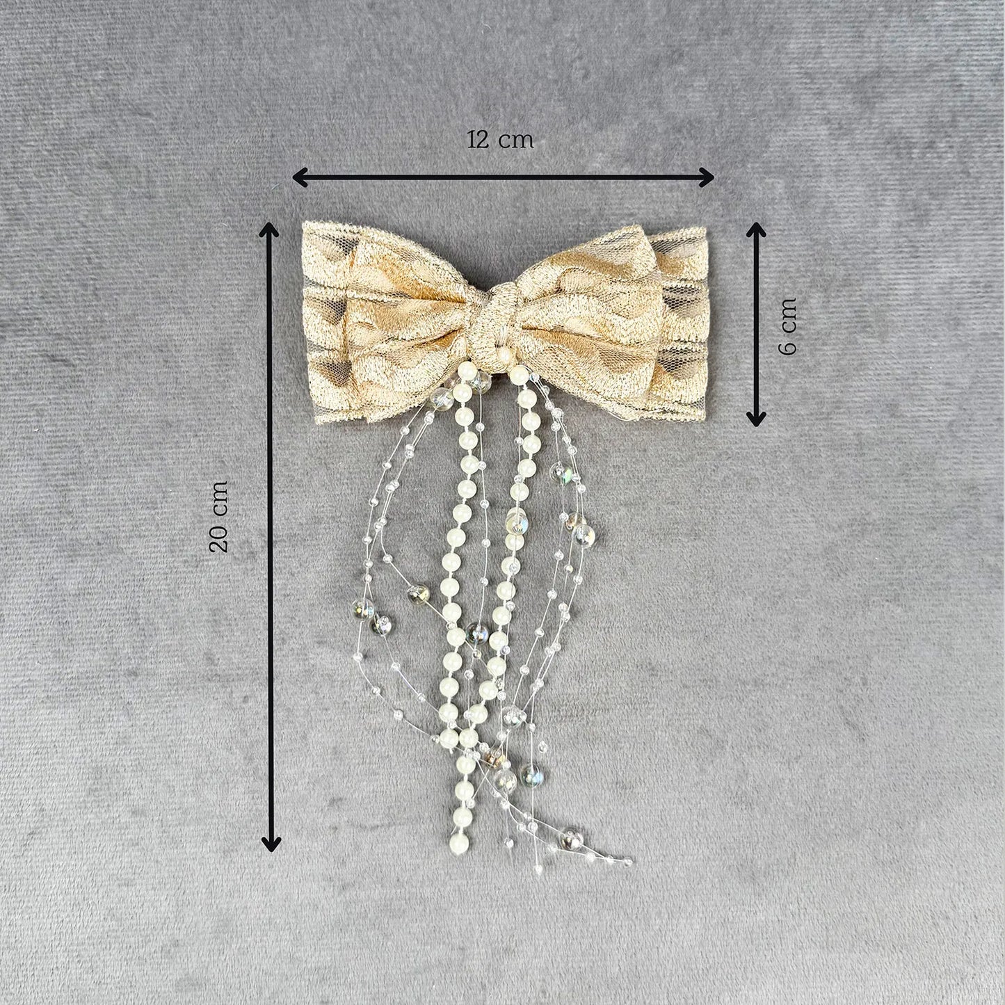 Decorative bow with beads and measurements on a gray background