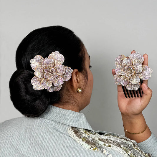 Woman with a decorative floral side hair comb against a plain background