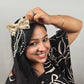 Woman wearing a decorative headpiece with a plain background