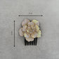 Decorative side hair comb with floral design and measurements on a gray background