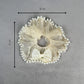 Off white scrunchie with bow and pearls on a gray background, shown with measurements.
