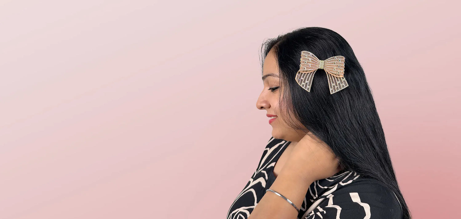 Woman with a decorative hair clip on a pink background
